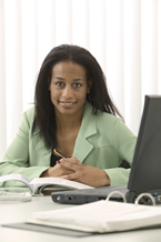 financial aid professional sitting at her computer